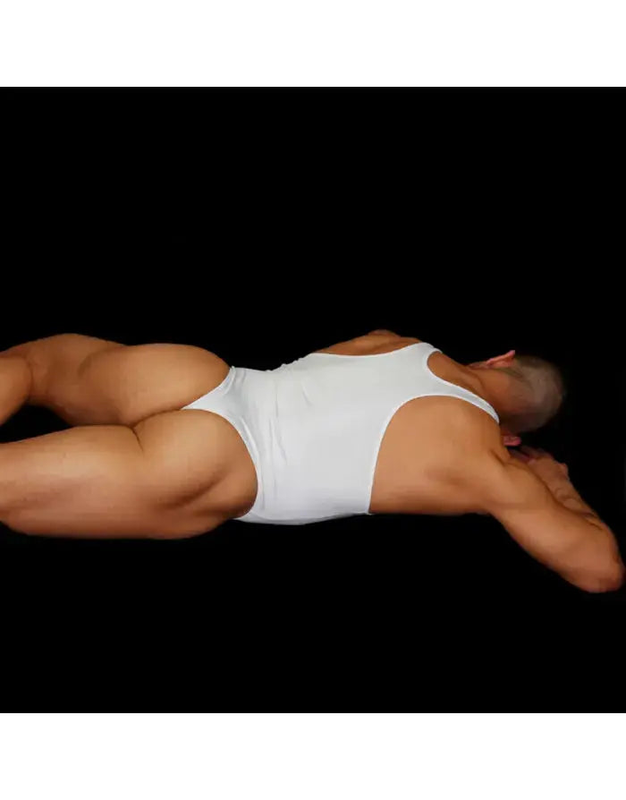 White thong bodysuit made of soft fabric featuring a sleeveless design shown on a model lying down by Arroyman.