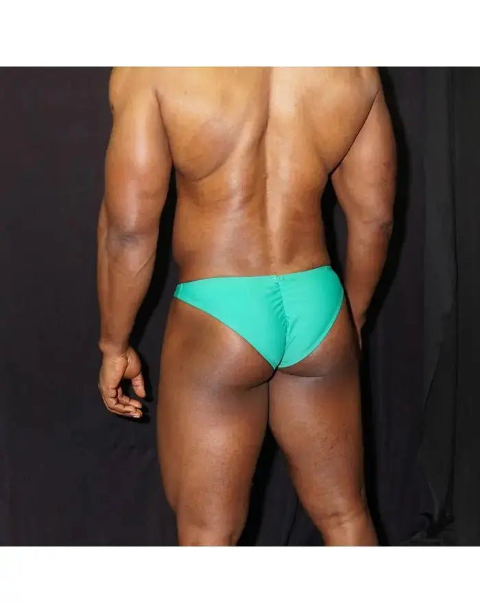 Green bodybuilding bikini by Arroyman featuring a snug fit and minimal coverage shown on a model from the back.
