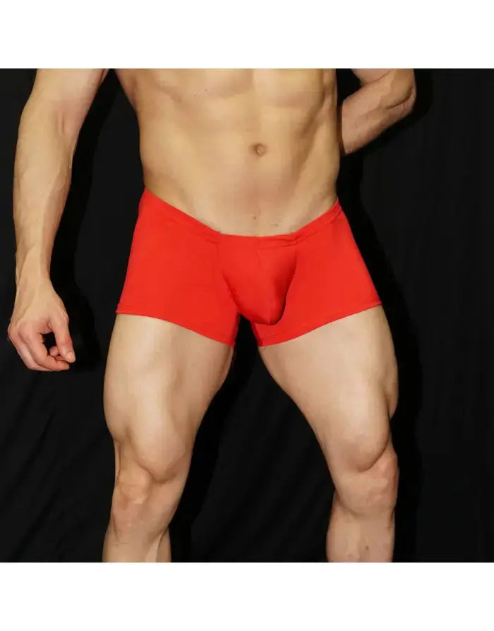 Red boxer underwear by Arroyman featuring a snug fit and soft material shown on a model against a dark background.