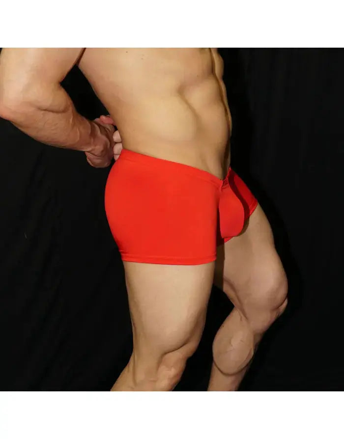 Red boxer underwear made of soft fabric featuring a snug fit and elastic waistband modeled by a man by Arroyman