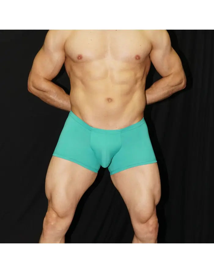 Turquoise boxer underwear by Arroyman featuring a snug fit and soft material shown on a model with a muscular build.