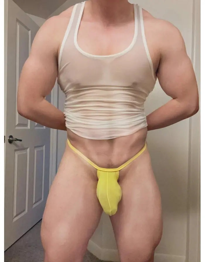 Model wearing yellow ribbed G-string underwear by Arroyman featuring a snug fit and minimal coverage.
