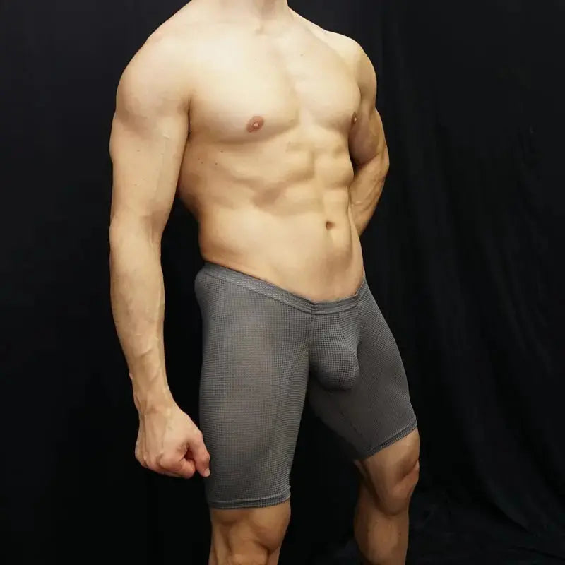 Men's grey mesh runner shorts by Arroyman featuring a snug fit and bulge-enhancing design shown on a model.