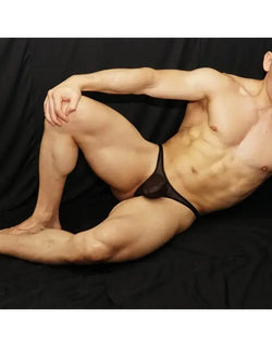 Black nylon thong underwear by Arroyman featuring a sheer front and minimal coverage modeled on a male figure.