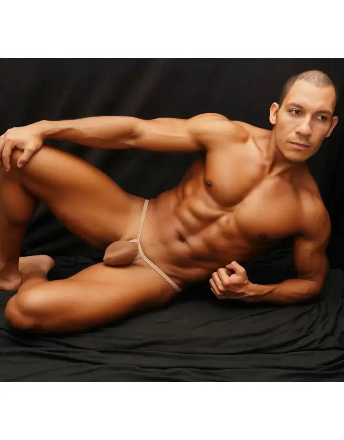 Nude ribbed G-string thong by Arroyman featuring a bulge pouch shown on a model against a black background.
