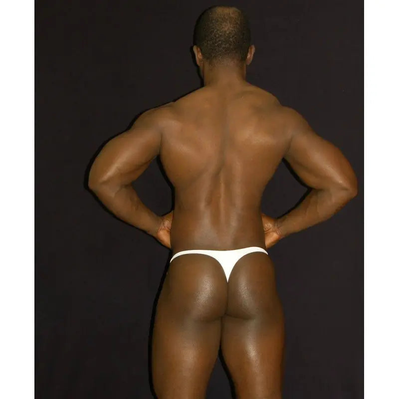 White thong underwear displayed on a model from the back showcasing the fit and design by Arroyman.