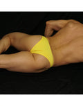 Yellow micro bikini underwear by Arroyman featuring a low-rise cut and smooth fabric shown on a model lying down.