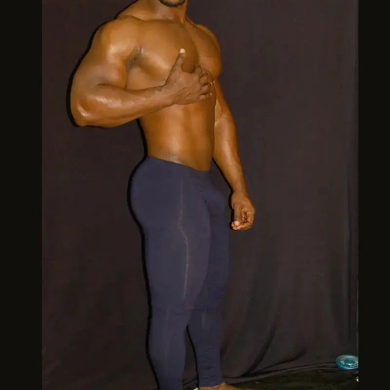 Navy spandex fitness tights by Arroyman featuring a fitted design worn by a model against a dark background.