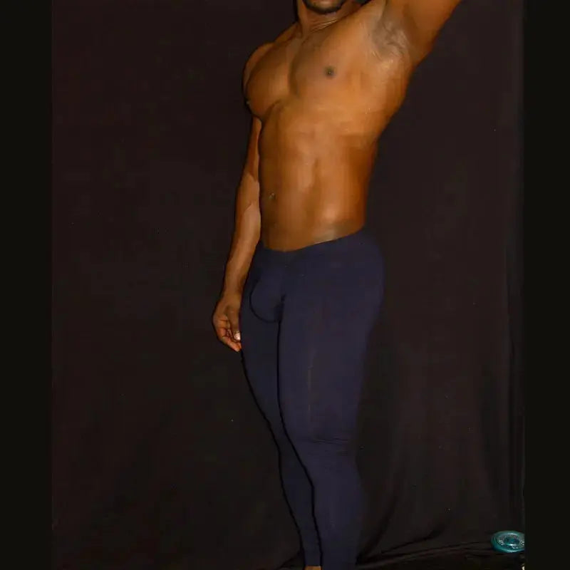 Navy spandex fitness tights by Arroyman featuring a snug fit and smooth texture shown on a model against a dark background.