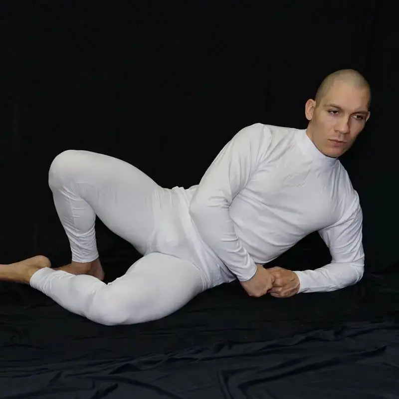 White spandex fitness tights by Arroyman featuring a fitted design and smooth texture worn by a model in a relaxed pose.