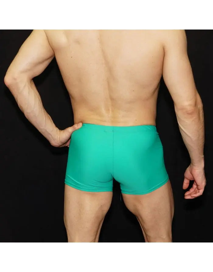 Men's green square cut swimwear by Arroyman featuring a snug fit and smooth fabric shown from the back.