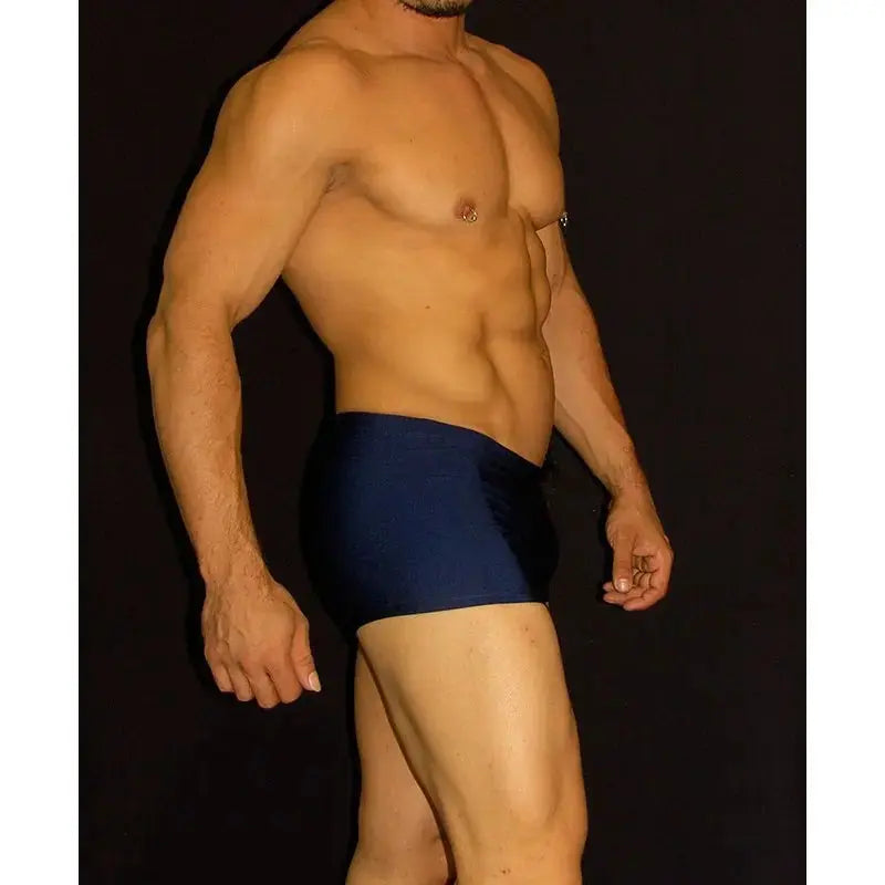 Navy square cut boxer swimwear by Arroyman featuring a snug fit and smooth fabric shown on a model from the side.