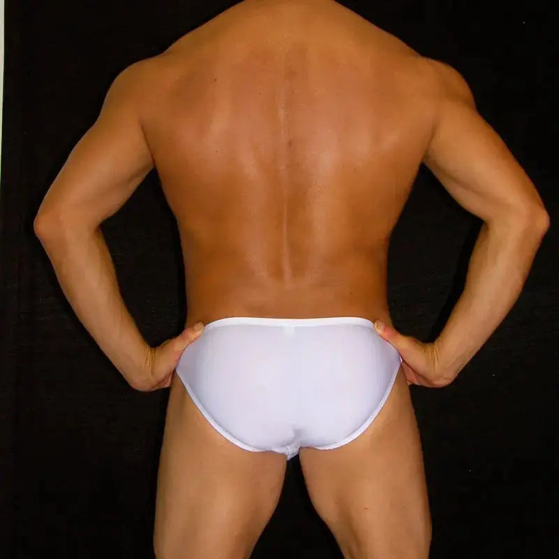 White bikini swimsuit by Arroyman featuring a snug fit and minimal coverage shown from the back on a model.