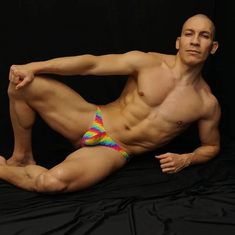 Arroyman rainbow patterned low-rise thong underwear worn by a model.