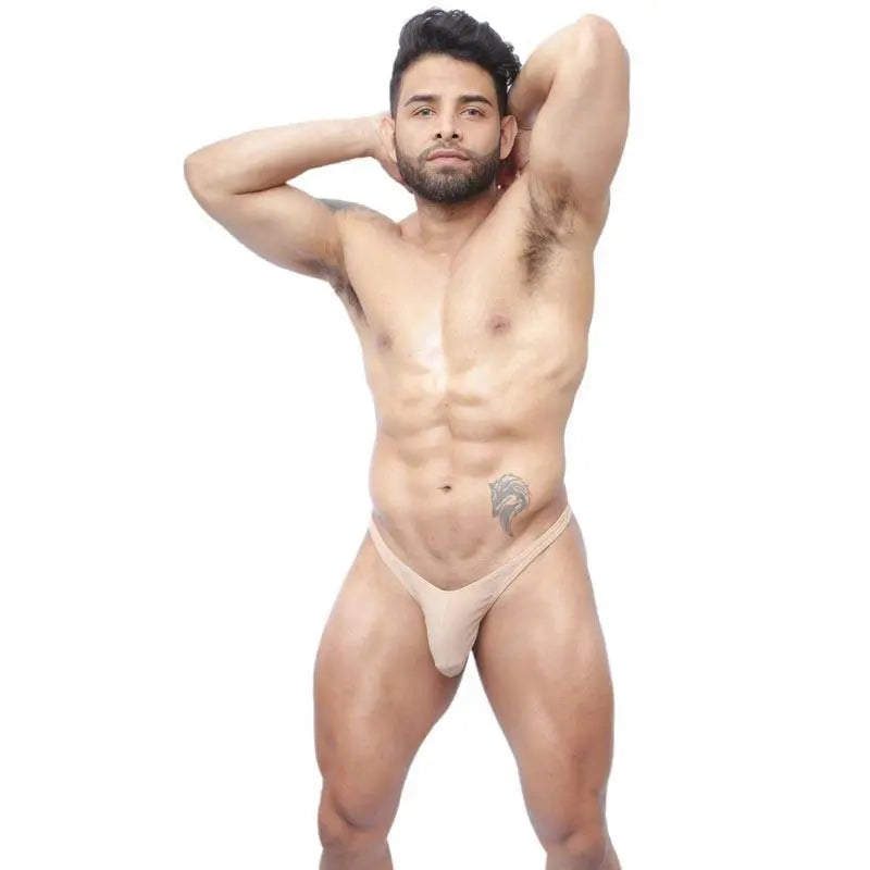 Nude thong underwear by Arroyman featuring a minimal design soft fabric and a comfortable fit modeled by a man.