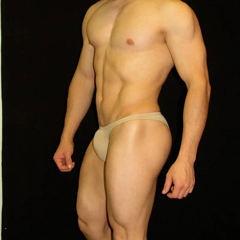 Nude micro bikini underwear by Arroyman featuring a minimal coverage design soft fabric and a snug fit modeled on a male figure.