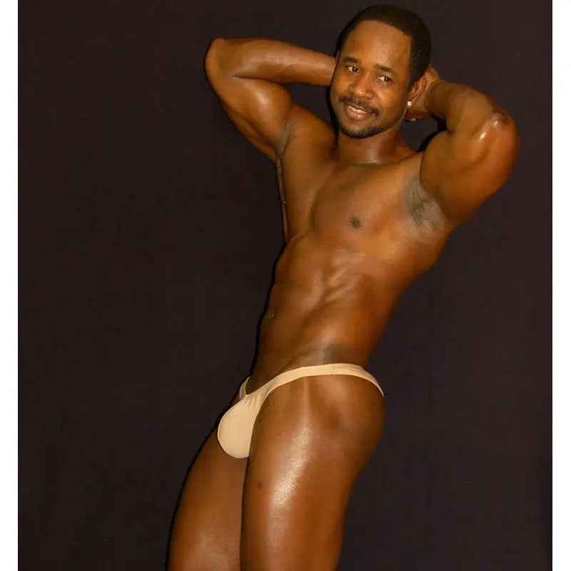Nude micro bikini underwear by Arroyman featuring a minimal design and soft fabric modeled by a man.