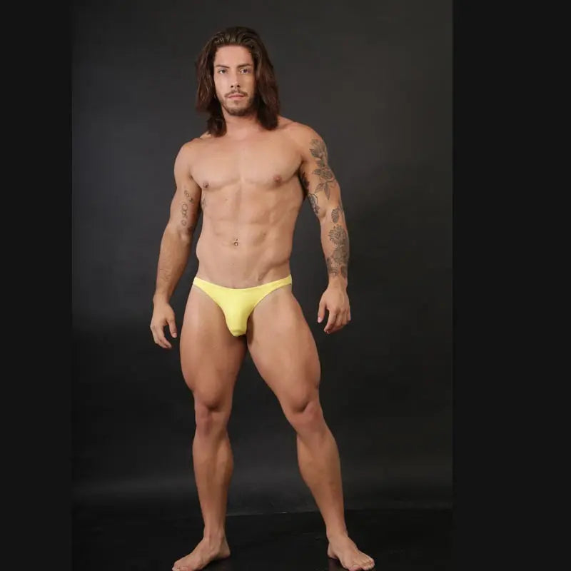 Yellow backless bikini underwear by Arroyman featuring a minimal design shown on a model with a toned physique.
