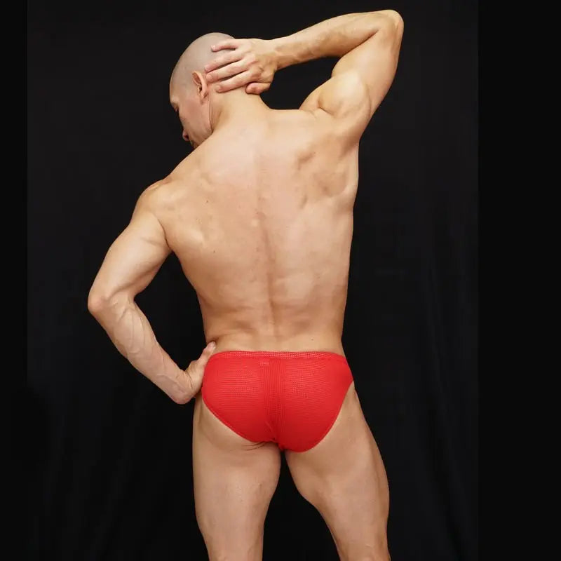 Red mesh bikini underwear by Arroyman featuring a snug fit and breathable fabric shown on a model from the back.