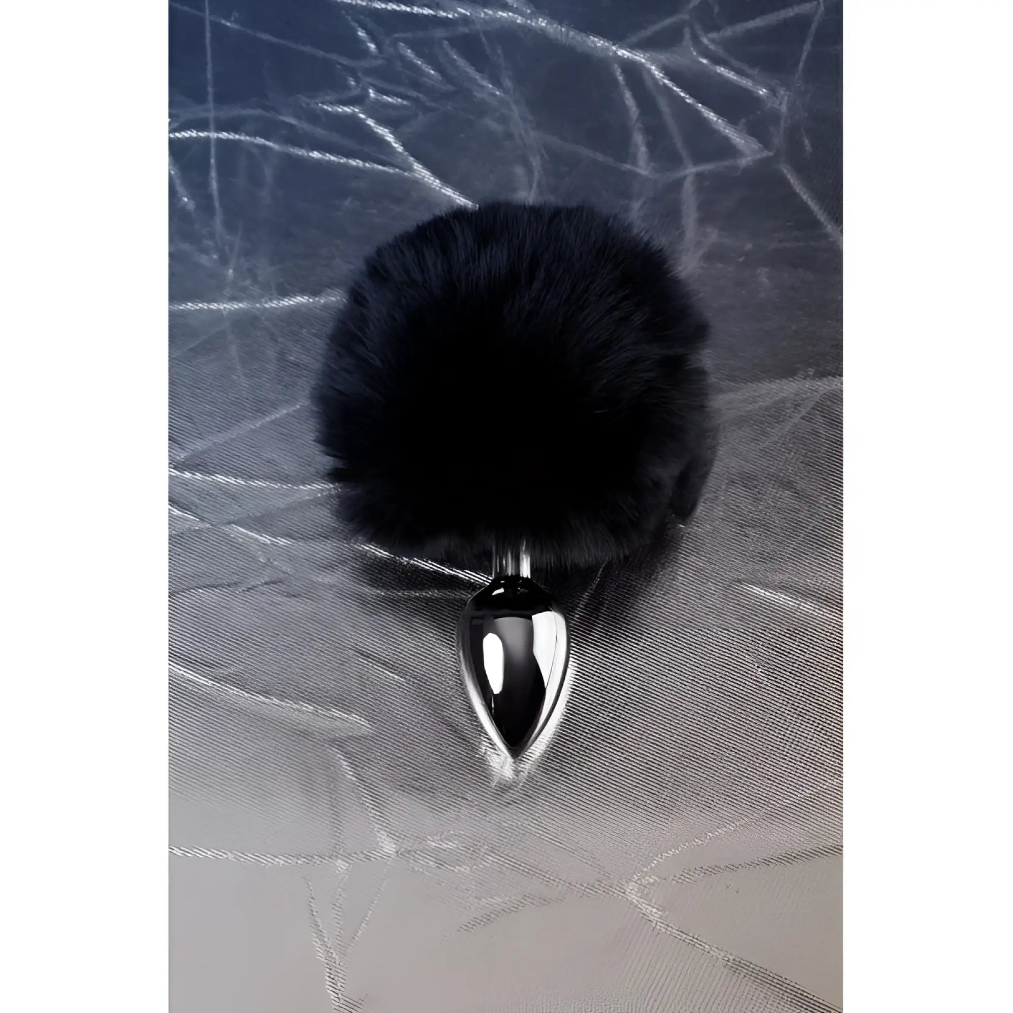 Black faux fur covered small metal anal plug with sleek silver polished base for discreet intimate use