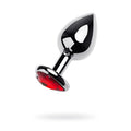 Shiny chrome-plated metal anal plug with a faceted red ruby heart crystal set into the base