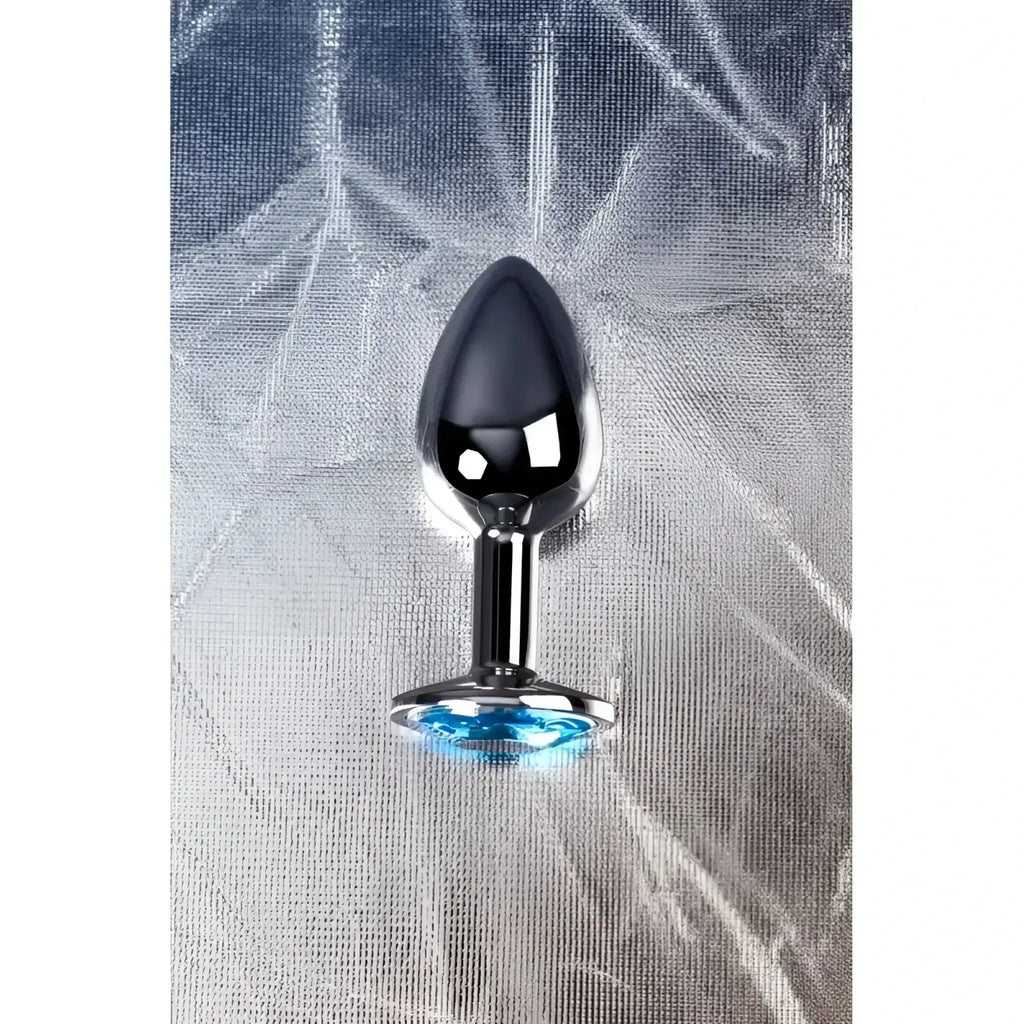 Small shiny chrome-plated metal silver anal plug with a faceted blue topaz crystal accent at the base