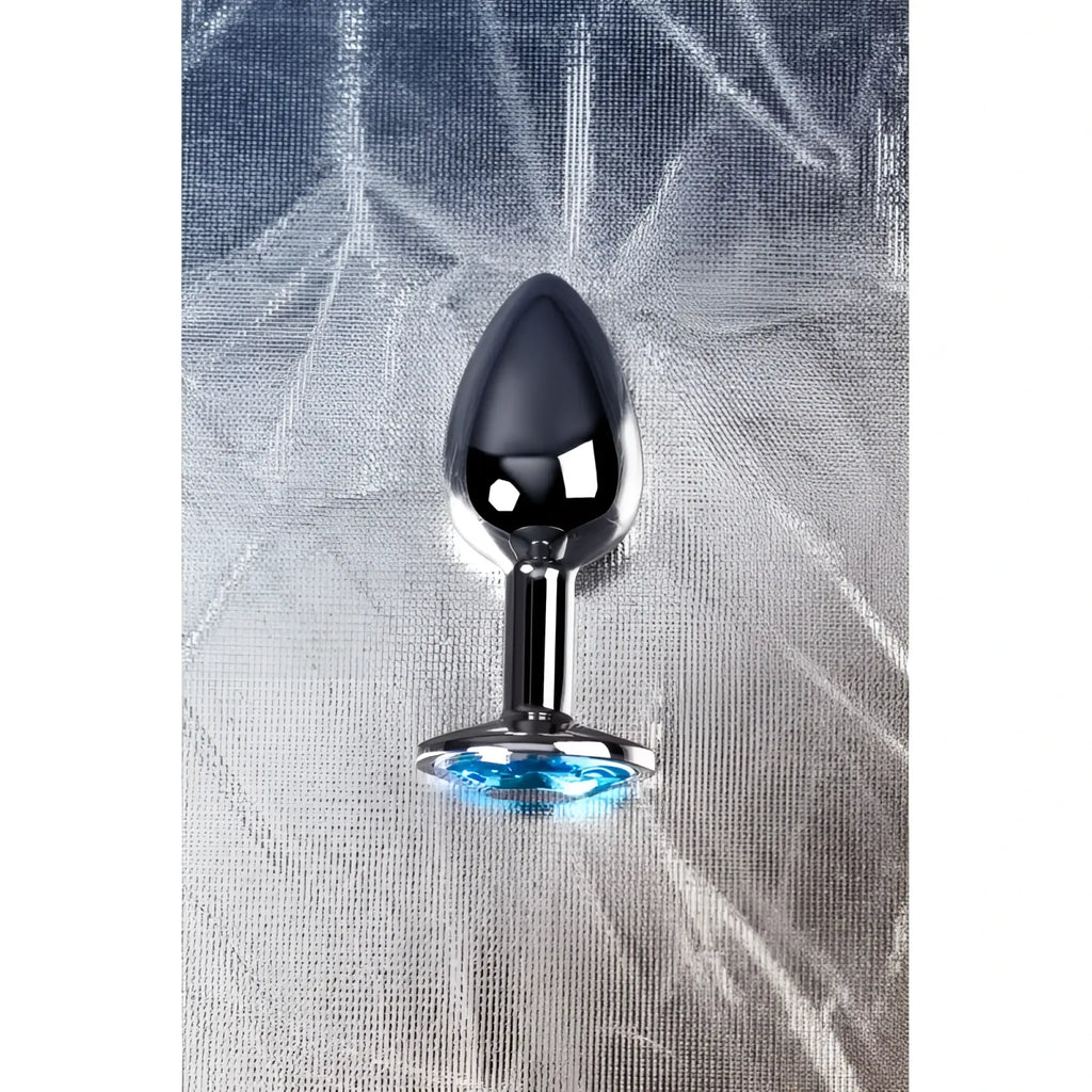 Small shiny chrome-plated metal silver anal plug with a faceted blue topaz crystal accent at the base