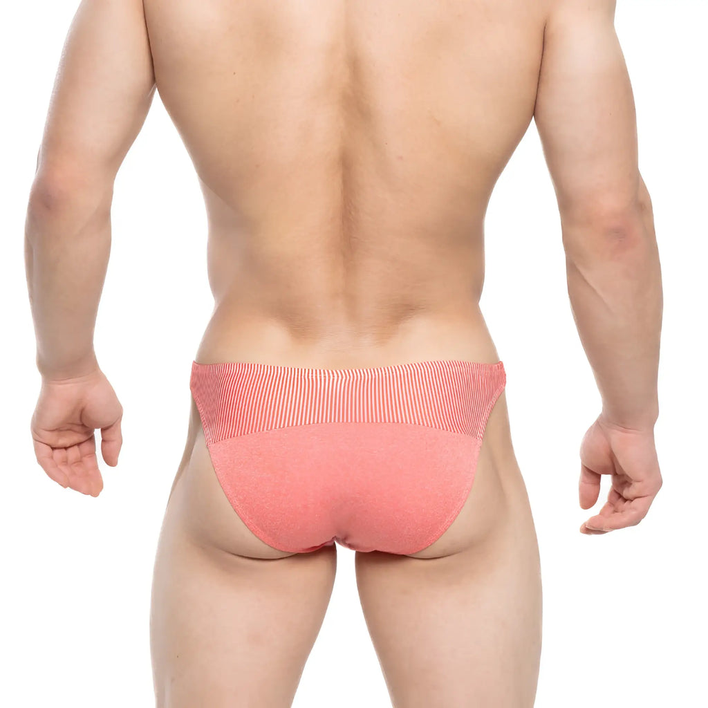 Coral-colored metro male wear awesome bikini briefs with ribbed waistband and textured fabric