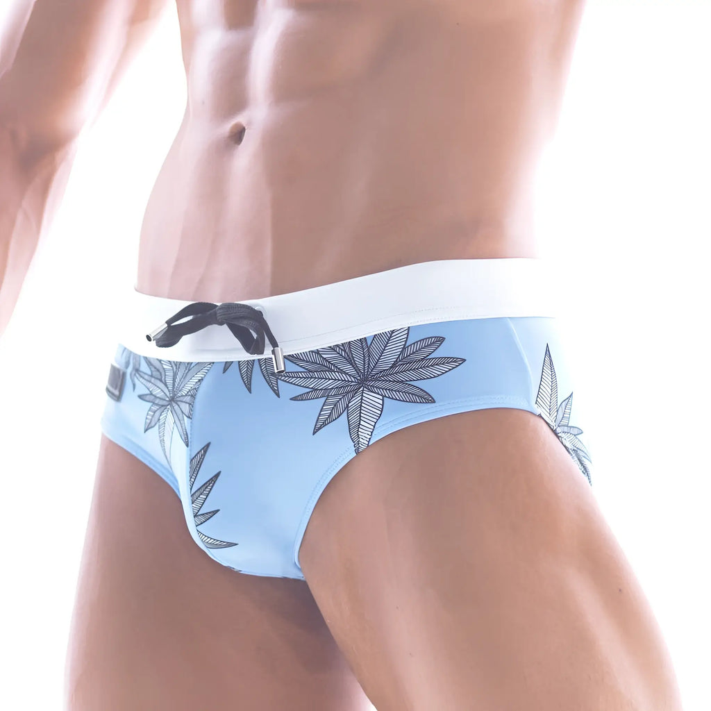 Light blue metro male wear beach swim brief with white waistband and black leaf pattern for summer swimwear