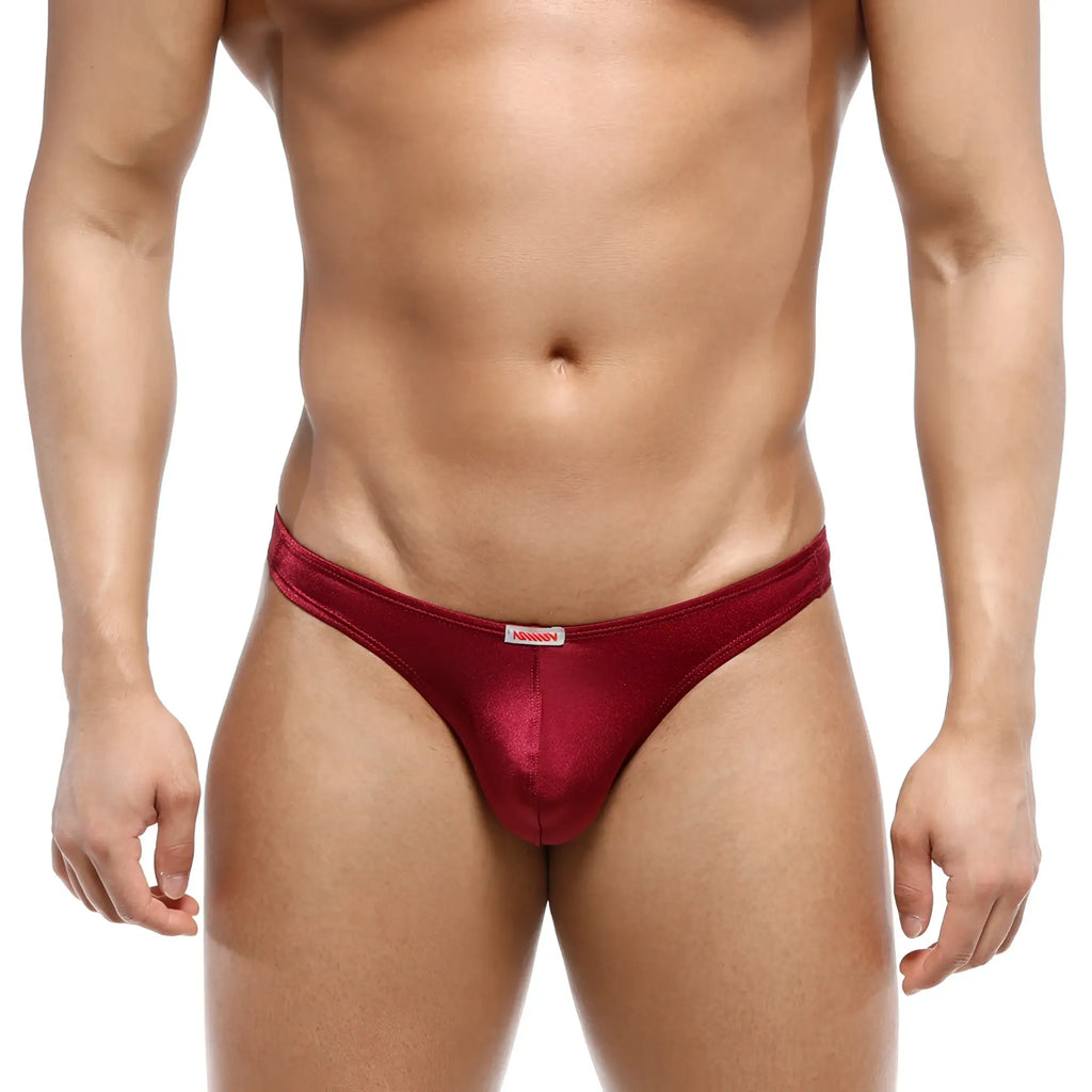 A shiny deep red satin thong with a white brand tag from metromalewear bulge capri bikini wine 6104-29