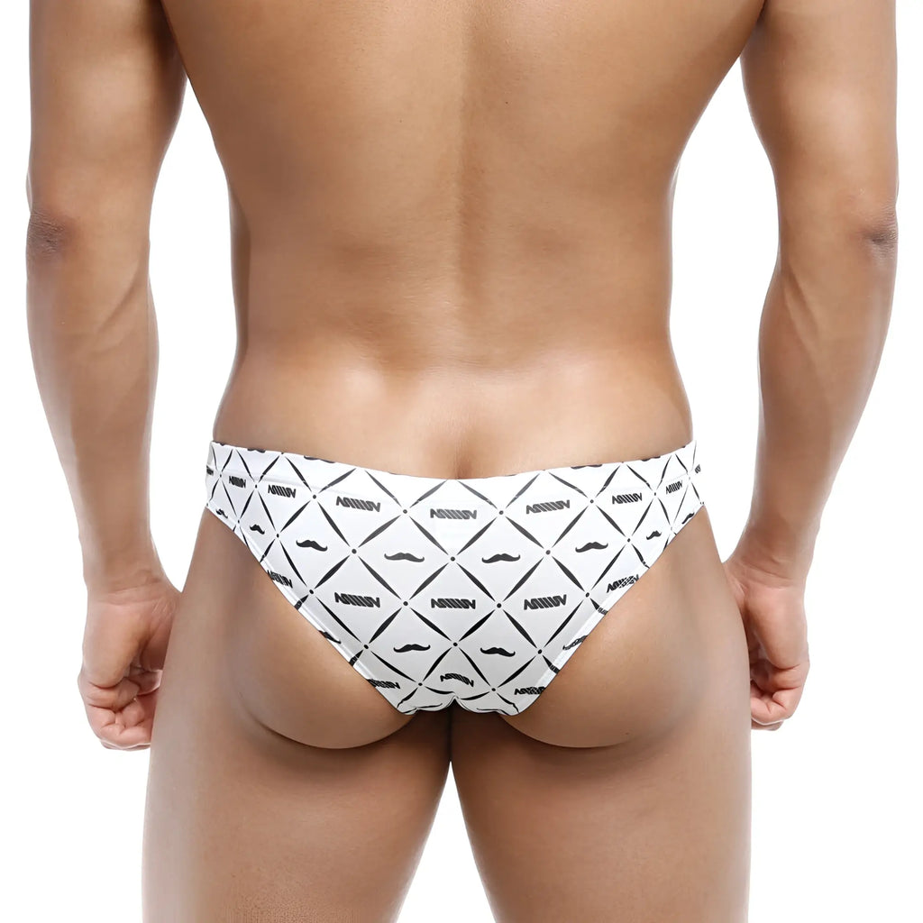 White swim trunks with black geometric mustache patterns and nassim branding from metromalewear capri bikini caballero 6103-03