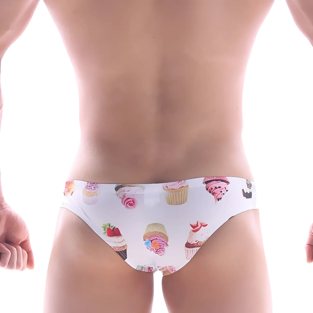 White metro malewear capri bikini swim trunks with colorful cupcake and frosting pattern for casual beachwear