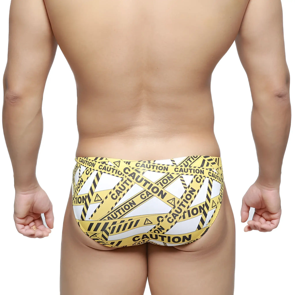 MetroMaleWear caution bikini swim trunks feature yellow and black caution tape pattern for bold beachwear style