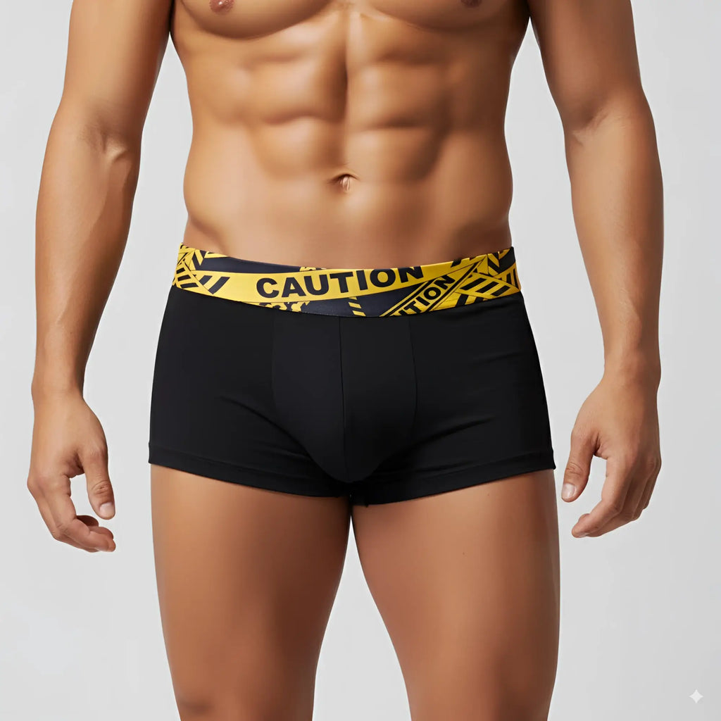 Black boxer briefs with bold yellow caution tape patterned waistband by MetroMaleWear model caution short boxer 2026-74