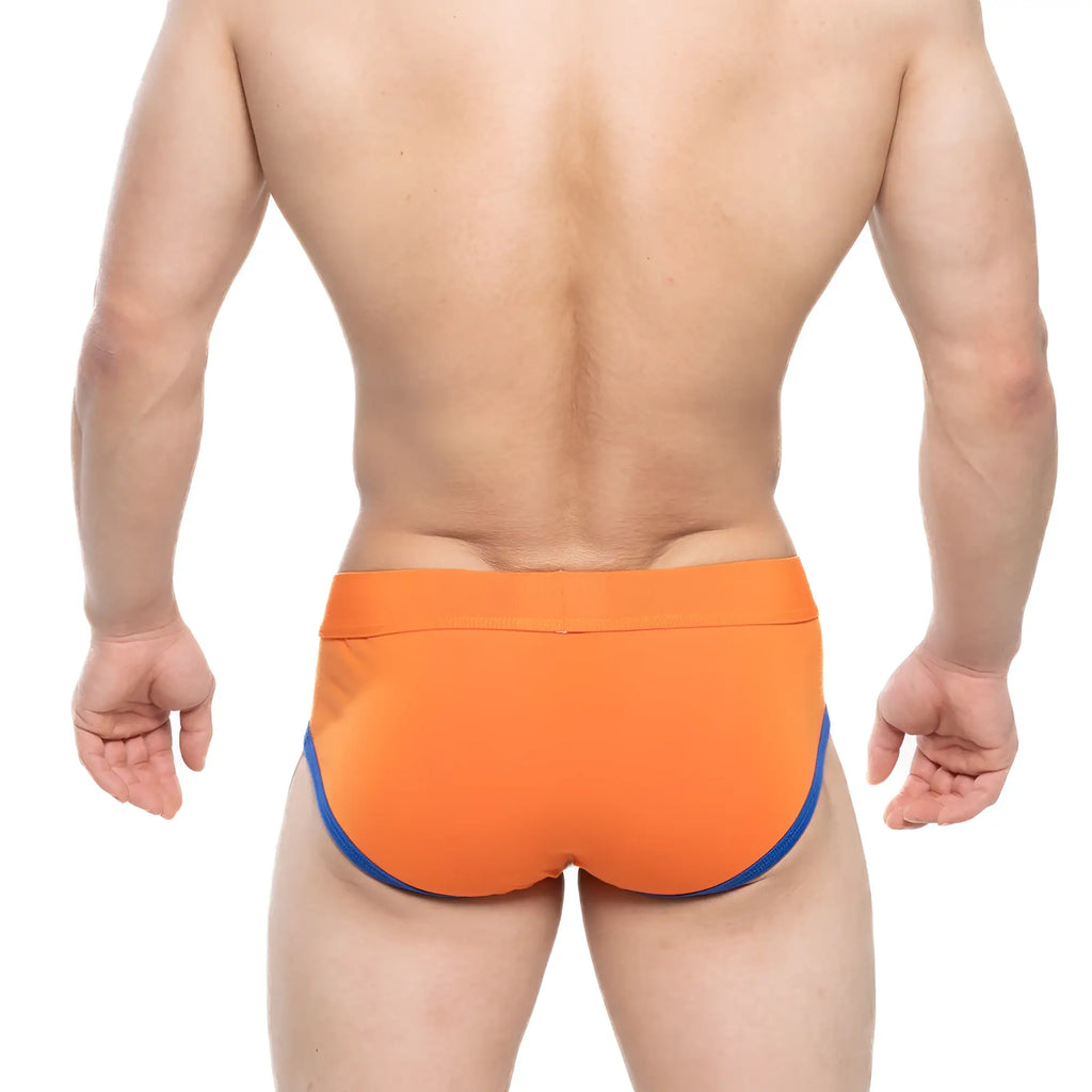 Bright orange MetroMaleWear Ciclerut brief 9004-24 swim trunks with contrasting blue trim along the sides