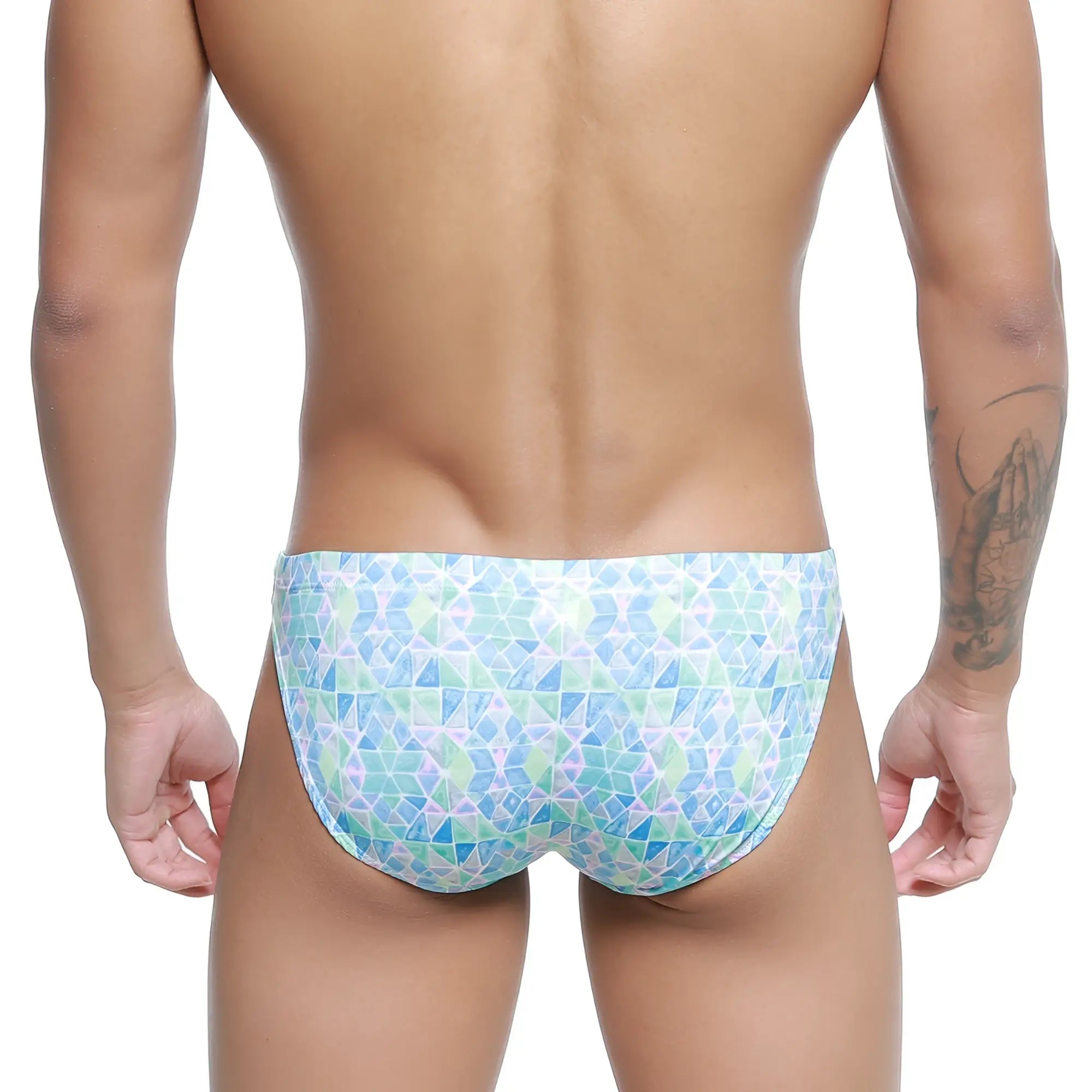 A man wearing MetroMaleWear classic swim bikini glass 4937-62 swim trunks with blue green and white geometric pattern