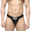 Black leather-like MetroMaleWear Deseo thong in metal black with white logo patch on waistband, front view