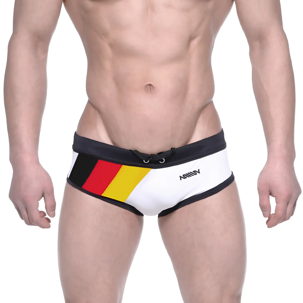 White swim trunks with black trim and bold german flag design on the side featuring ammy brand name metroMalewear