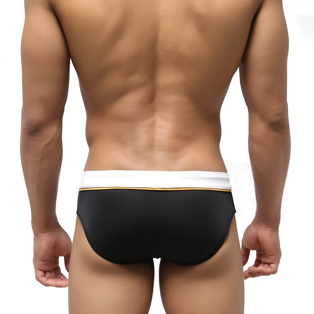 MetroMaleWear edge swim brief black with a white waistband and thin gold trim in a sleek swim trunk design