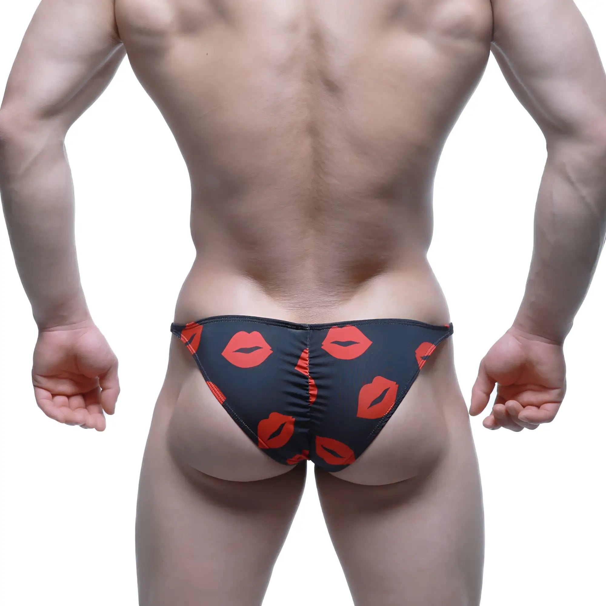Black swim trunks by MetroMaleWear featuring a bold red lipstick print pattern for stylish beachwear