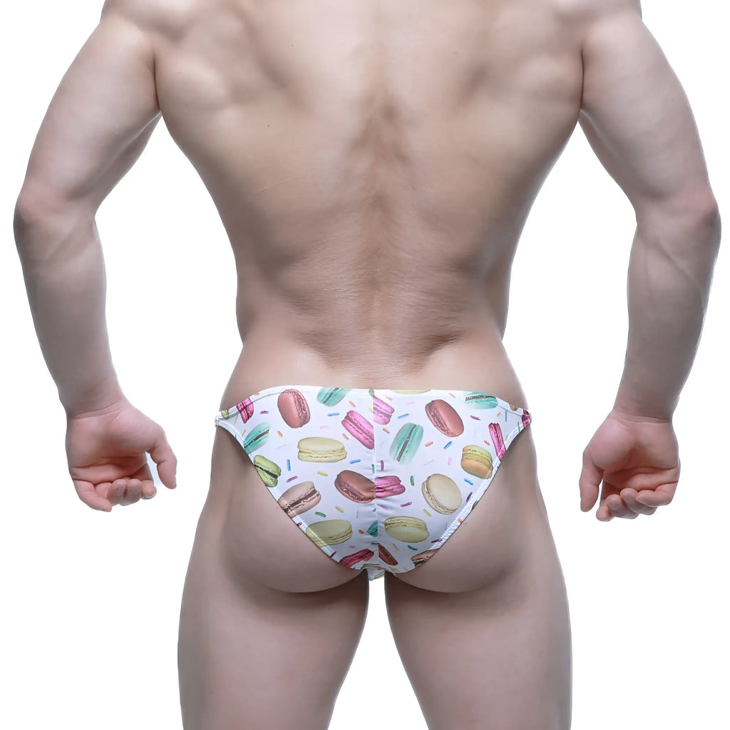 White swim trunks by MetroMaleWear featuring a playful colorful macaron and sprinkle pattern for beachwear