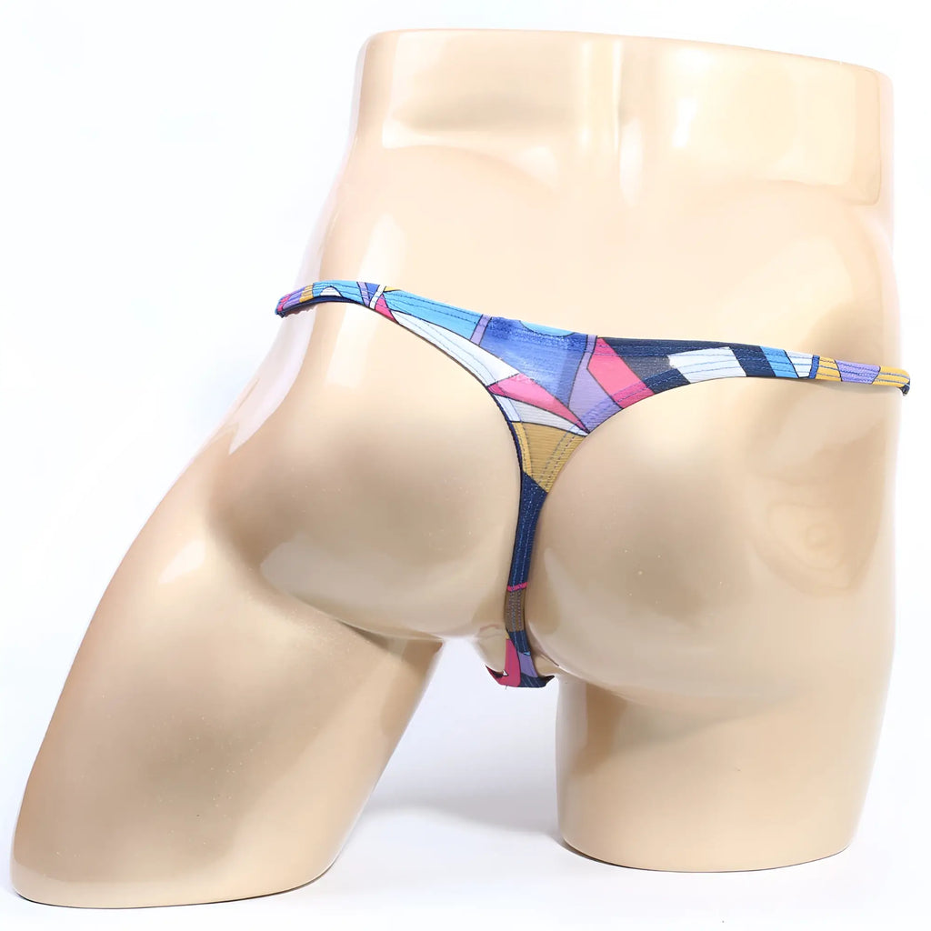 A vibrant geometric-patterned thong in blue pink and yellow with a thin elastic waistband from MetroMaleWear Fantasy Thong Picasso 6112-87