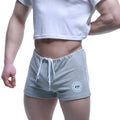 Gray heathered MetroMaleWear fit shorts with white drawstring and circular logo patch on lower left leg