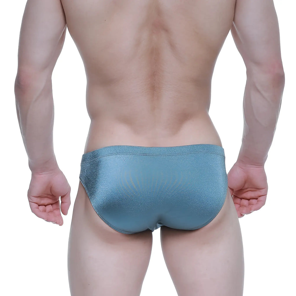 A sleek shimmering teal swim trunks with a smooth glossy finish from metromalewear forest bikini 5103-m03 collection