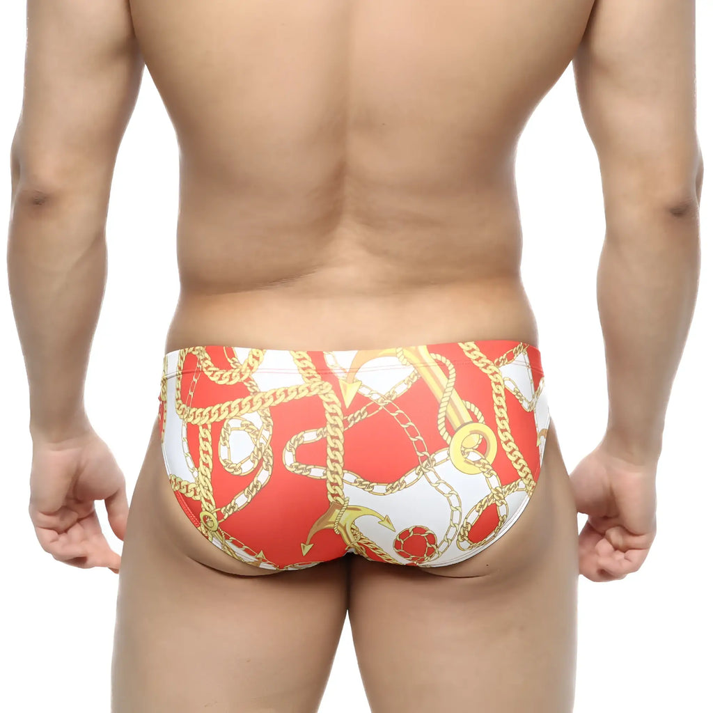 MetroMaleWear Lujo bikini red swim trunks with bold gold chain and anchor pattern in red and white