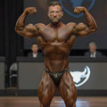 A muscular man wearing leopard-print MetroMaleWear luxury swim bikini briefs front view
