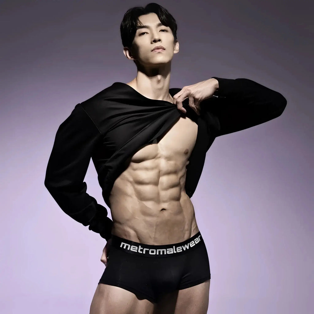 Black MetroMaleWear trunk underwear featuring a branded elastic waistband on a shirtless man.