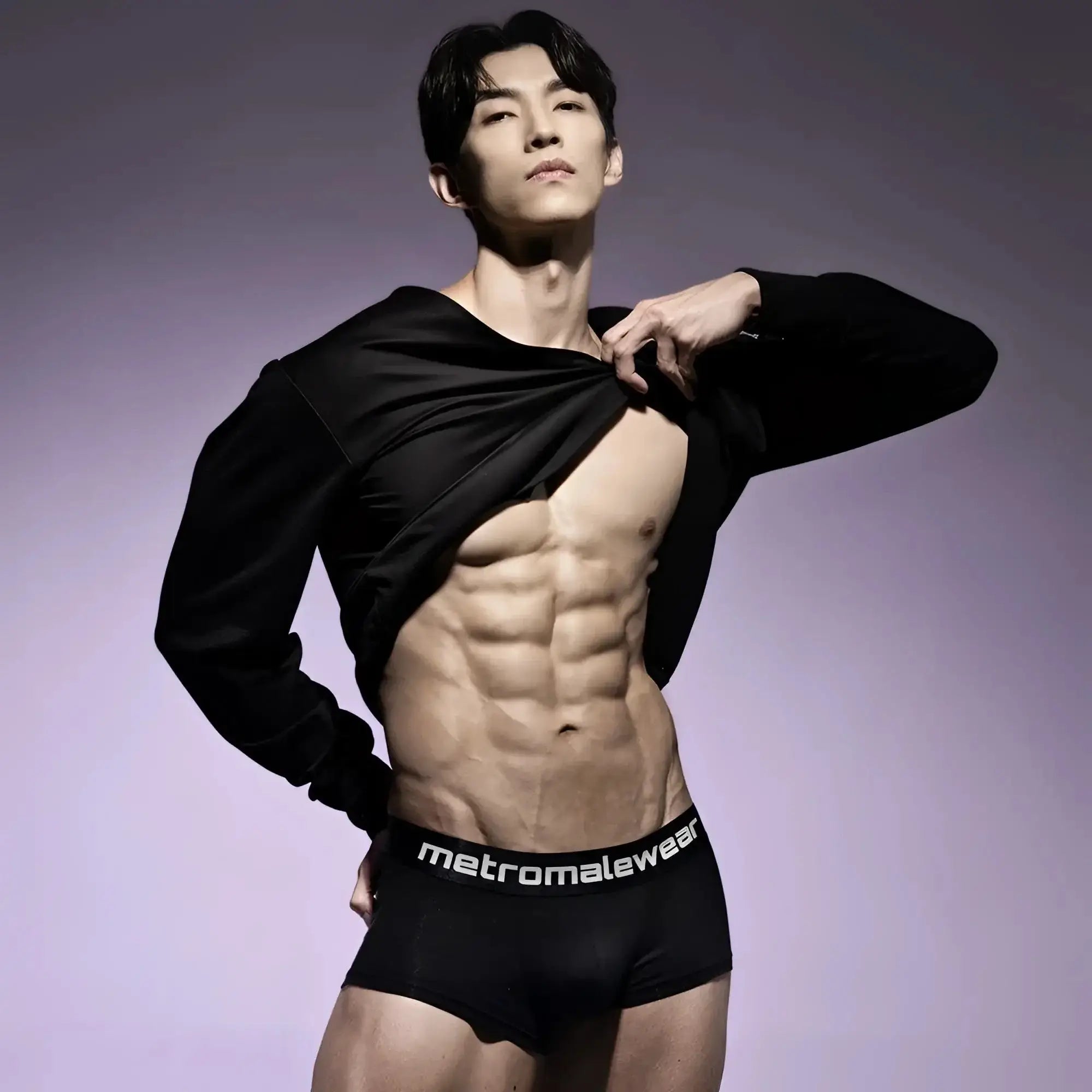 Black MetroMaleWear trunk underwear featuring a branded elastic waistband on a shirtless man.