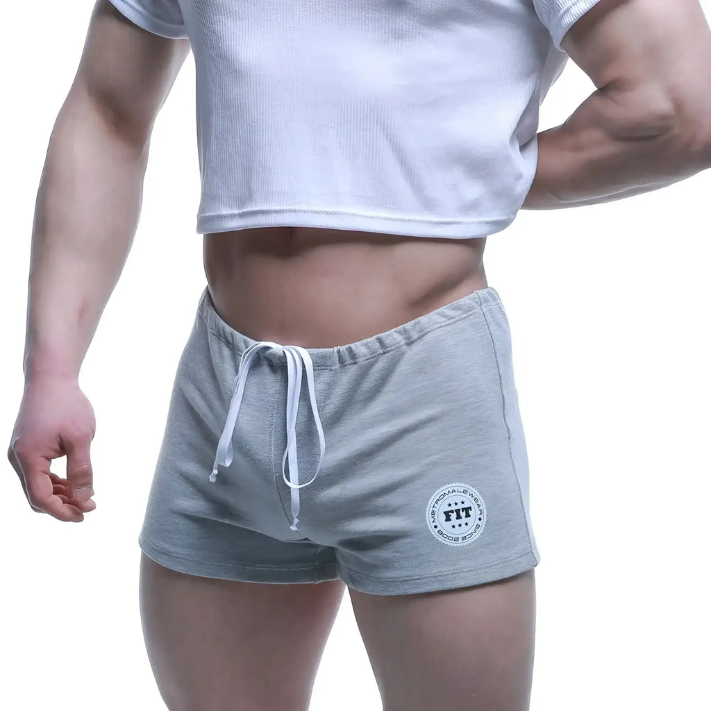Gray heathered MetroMaleWear fit shorts with white drawstring and circular logo patch on lower left leg