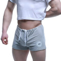 Gray heathered MetroMaleWear fit shorts with white drawstring and circular logo patch on lower left leg